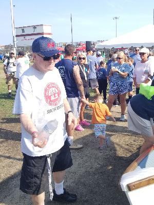 Photo of my dad handing out water bottles before the walk